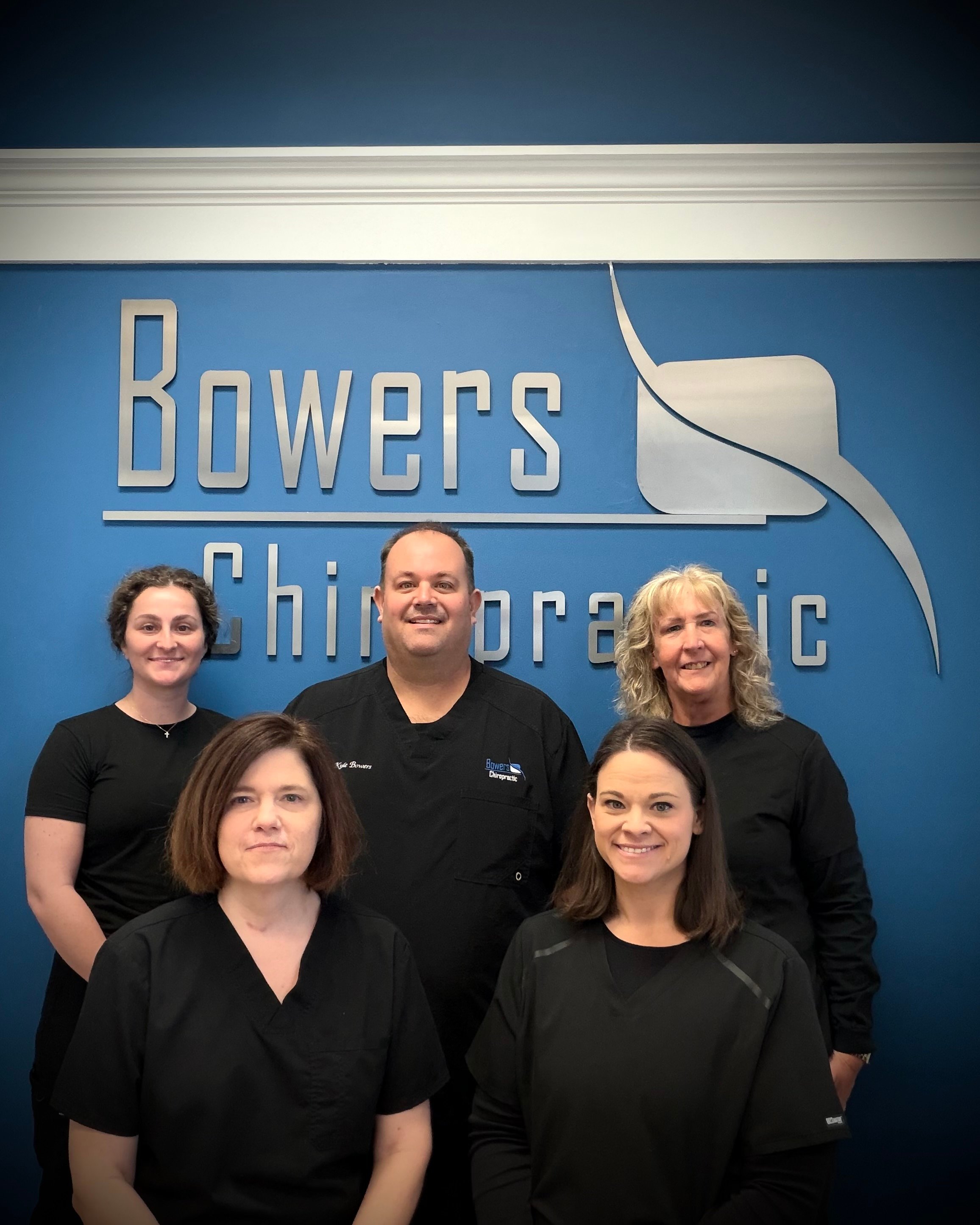 Dr. Kyle Bowers and the Bowers Chiropractic team standing in their Columbia, MO office